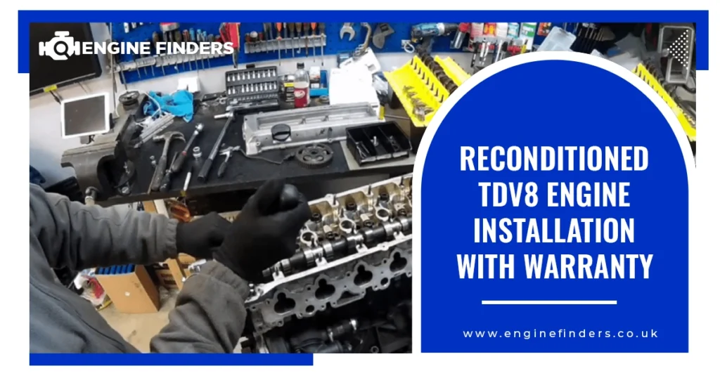 Mechanic installing a reconditioned TDV8 engine in a workshop with tools.